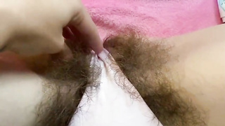 Enthralling cougar is delicately finger-banging her unshaved fuckbox in front of the camera, just for joy