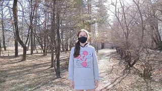 Mischievous stunner is dressed in a mask while ambling around the local park bottomless, during the day
