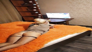 Outstanding light-haired girl with petite knockers is dressed in black fishnets while draining and deep-throating rod