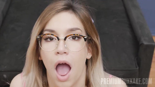 Adorable towheaded stunner with glasses, Megan Nicole is licking new spunk, in front of the camera