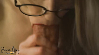Emma May is dressed in black glasses while wrapping her sensuous lips around a rock rigid weenie