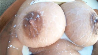 Humungous funbags get caressed and wrung rock-hard in a close-up before getting milk all over them