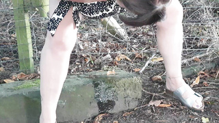 Slut takes a piss out side