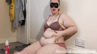 Wild PLUMPER is dressed in softcore undergarments while slurping chocolate cake, in front of the camera