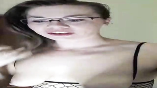 Horny dark haired in black fishnets is jerking with a orgy fucktoy, in front of the camera