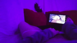 Chick POINT OF VIEW of a nymph draining in a dim-lit apartment while observing manga porn on her smartphone