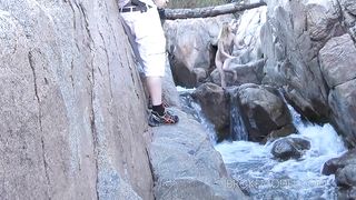 Kinky chick stretching at kinky waterfall