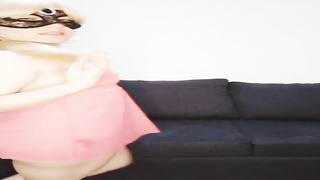 All-innate nymph is dressed in nothing but a black mask while tugging on the sofa