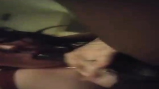 Nerdy honey is blowing a large, black salami in front of the camera, just for joy