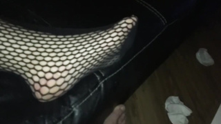 Honey in black fishnets is providing a feetjob to a fellow she has just encountered