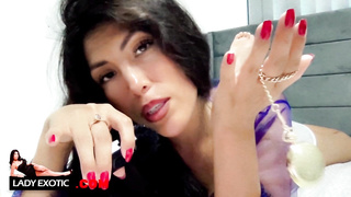 Doll Exotic is posing and taunting in front of the camera while dressed in wondrous clothes