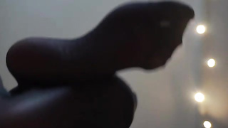 Honey with voluptuous soles is dressed in black nylons while posing and taunting, in front of the camera