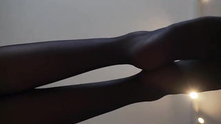 Honey with voluptuous soles is dressed in black nylons while posing and taunting, in front of the camera