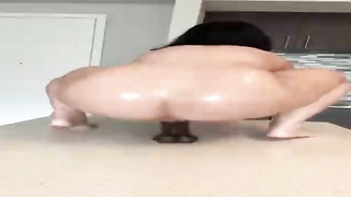 Super-Naughty woman with a hefty, rigid arse is juggling up and down while railing a black fake penis