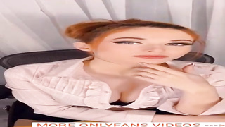 Fabulous stunner with crimson hair, Amour is toying with her hefty bosoms in front of the camera