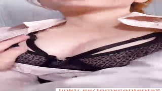 Fabulous stunner with crimson hair, Amour is toying with her hefty bosoms in front of the camera