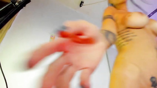 Bare black-haired with ample, rock hard mounds and tats is smoking in front of the web camera