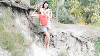 Bare teenies are pawing each other in the nature, in the middle of the day