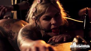 Ball-Gagged, inked platinum-blonde is being vibed from the back and squealing from enjoyment while nutting