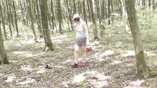 Upskirt no undies . Bare mother Cougar sans undies picks mushrooms in woods . Outdoors Outside