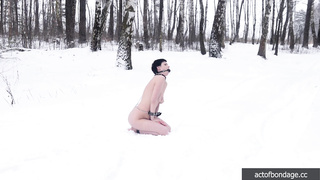 Naked barefoot Claudia chained in the snow