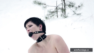Naked barefoot Claudia chained in the snow