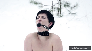 Naked barefoot Claudia chained in the snow