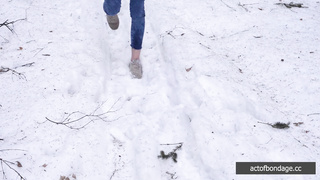 Barefoot Claudia is captured in the cold winter forest