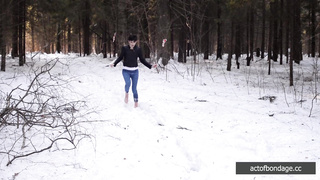 Barefoot Claudia is captured in the cold winter forest