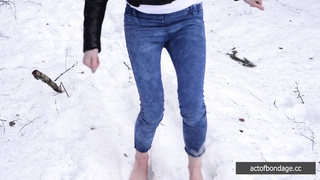 Barefoot Claudia is captured in the cold winter forest