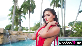 Glamorous naked babe posing by the pool