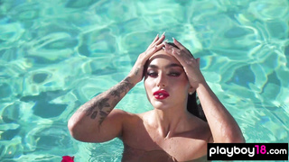 Glamorous naked babe posing by the pool