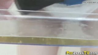 Asian stunner urinates thru undies