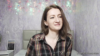 Brunette amateur babe posing clothed on solo webcam