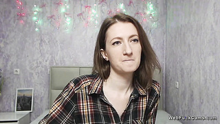 Brunette amateur babe posing clothed on solo webcam