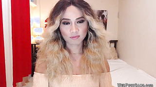 Blonde shemale wanks off in chair in front of webcam