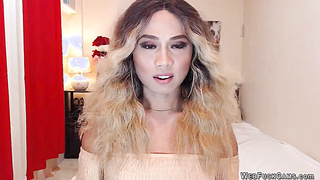 Blonde shemale wanks off in chair in front of webcam