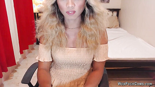 Blonde shemale wanks off in chair in front of webcam