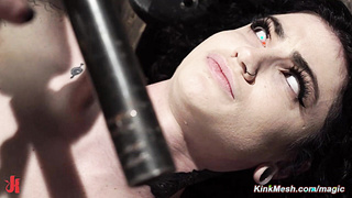 Tattooed brunette slave locked in metal and fucked