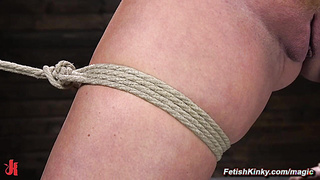 Curvy slave endures flogging in bondage in dungeon