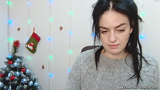 Brunette babe in grey sweater posing