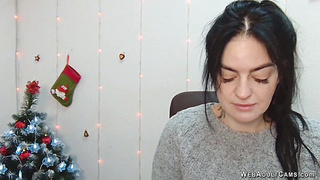 Brunette babe in grey sweater posing