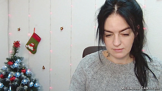 Brunette babe in grey sweater posing