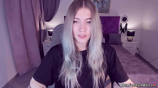 Blonde teen smoking and stripping off