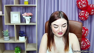 Busty redhead strips bra closeup