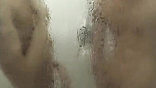 Tattooed twink KC Williams swallows throbbing cock in shower