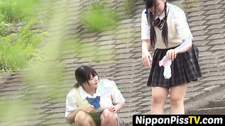 NipponPissTV.com - Two girls get caught pissing and filming each other outside publicly