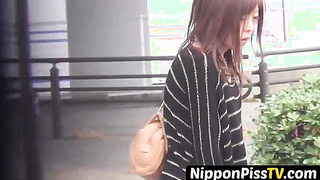 NipponPissTV.com - Real Japanese lady filmed while peeing in closeup outdoors