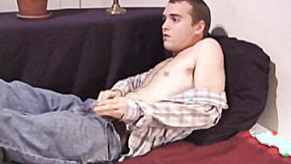 Good looking dude gets aroused while reading gay magazine