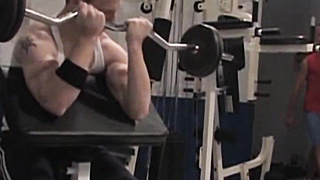 Back in the gym, cream-colored red-haired Tim Rusty pumps away at thepreacher curl while Joey O'Bryan works his gam raises.